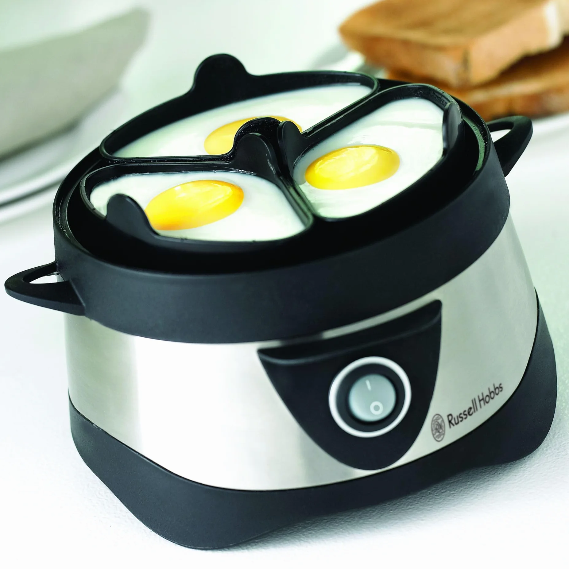 Russell Hobbs Cocedor de Huevos Cook@Home - Capacidad para Hervir 7 Huevos y Pochar 3 Huevos, Apagado Automático, Incluye Recipiente Medidor, Tapa Plástico, Acero Inoxidable - 14048-56