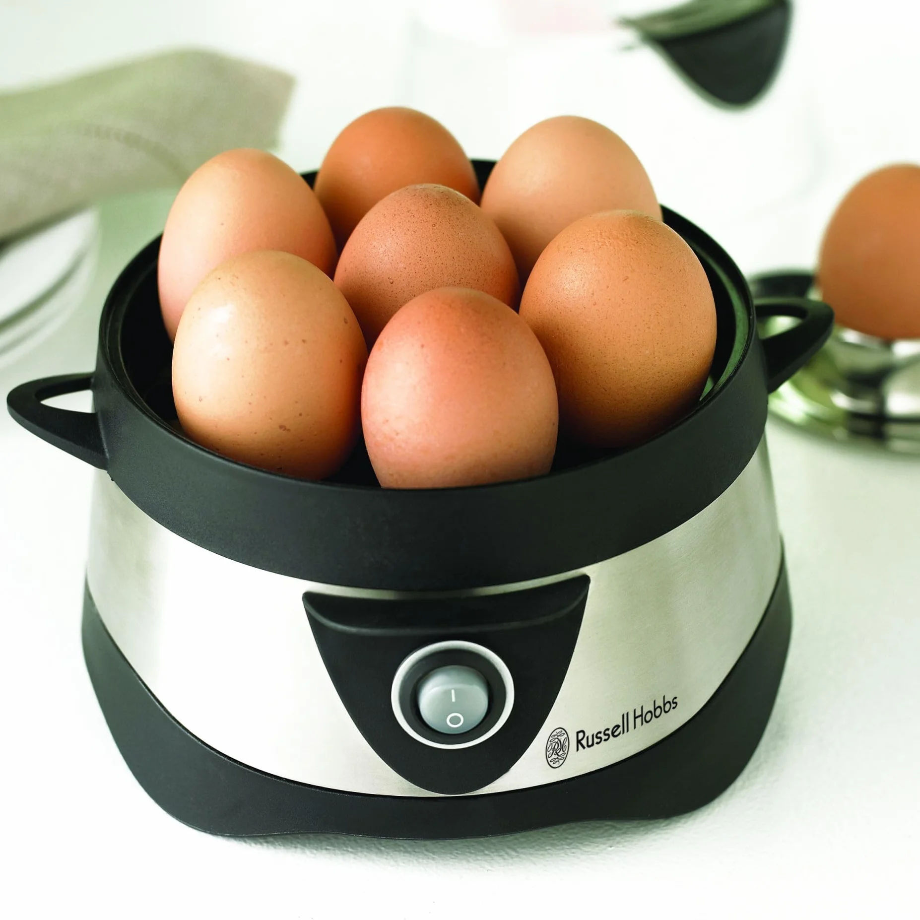Russell Hobbs Cocedor de Huevos Cook@Home - Capacidad para Hervir 7 Huevos y Pochar 3 Huevos, Apagado Automático, Incluye Recipiente Medidor, Tapa Plástico, Acero Inoxidable - 14048-56